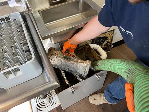 Cleaning restaurant kitchen grease trap maintenance